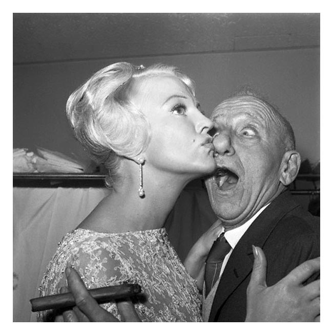 06 Feb 1961, New York, New York, USA --- Getting busted in the nose is nothing to sniff about, says Jimmy Durante, whose considerable schnozzle is smacked by shapely song star Peggy Lee. Both headliners are appearing in New York nightclubs: Jimmy at the Copecabana and Peggy at Basin Street East. --- Image by © Bettmann/CORBIS