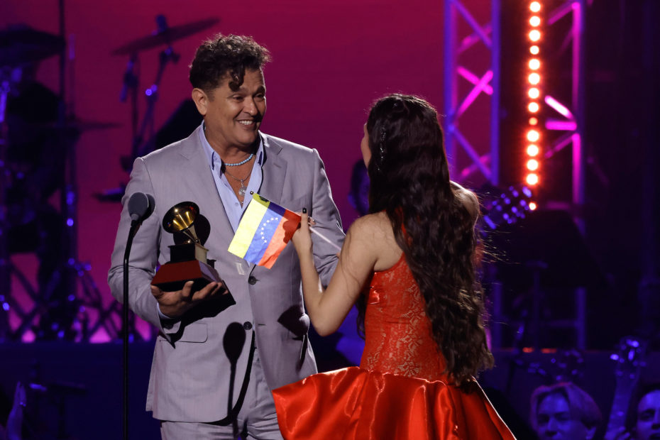 SEVILLE, SPAIN - NOVEMBER 16: (L-R) Carlos Vives presents the Best New Artist award to Joaquina onstage during The 24th Annual Latin Grammy Awards on November 16, 2023 in Seville, Spain. (Photo by Kevin Winter/Getty Images for Latin Recording Academy)